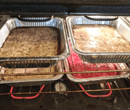 Four pans of cooked dog food in oven